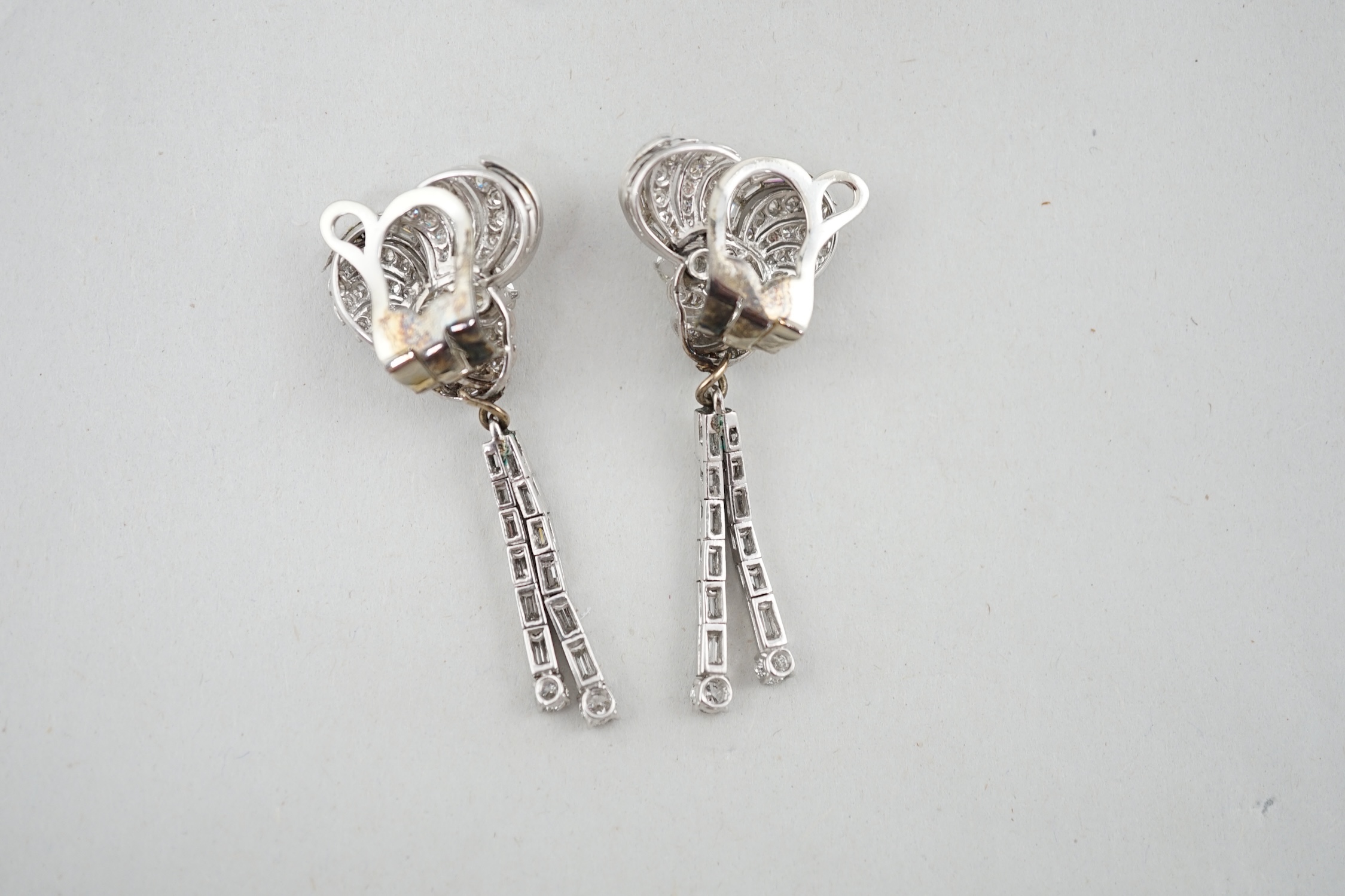 A pair of 1960's white gold and diamond cluster set drop ear clips